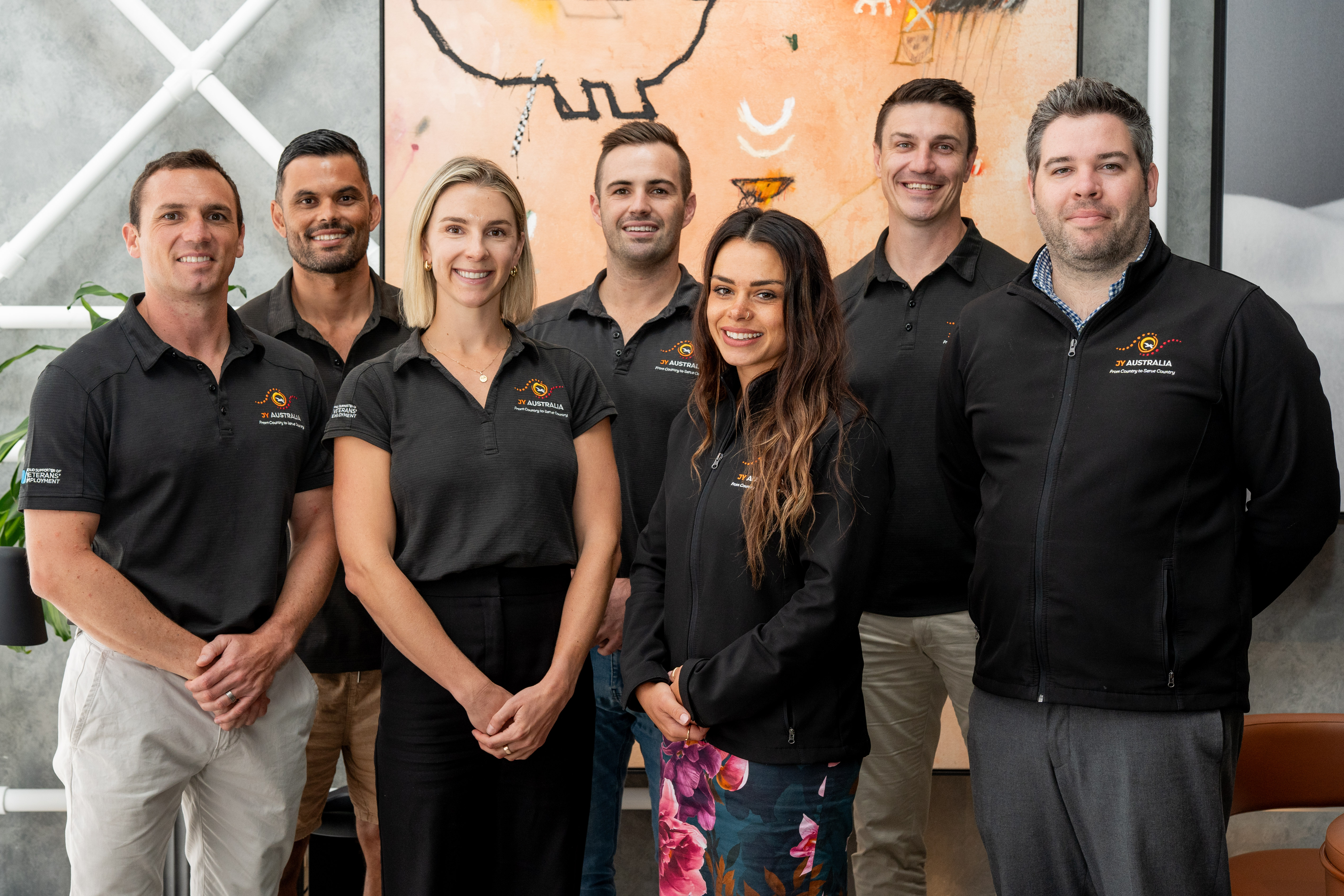 Six people in black tops with matching JY Australia logos