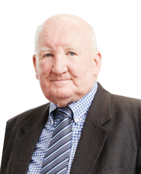 Colin McDowell in a dark suit, smiling and facing the camera.