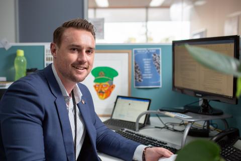 Man in suit sitting in a office environment